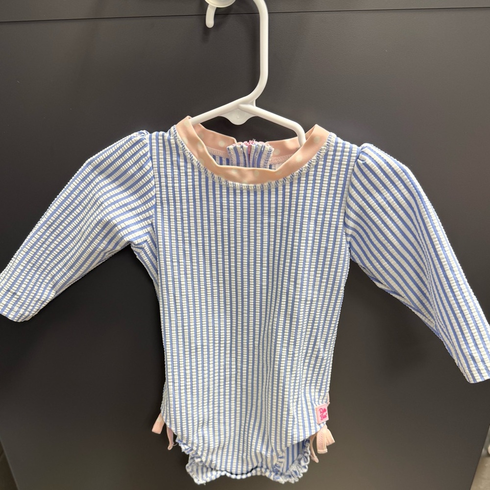 Ruffle Butts Blue Seersucker One-Piece Rash Guard Swimsuit
Size: 6–12 Months